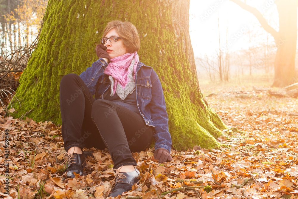 woman spending time in park during autumn season woman spending time in park during autumn season