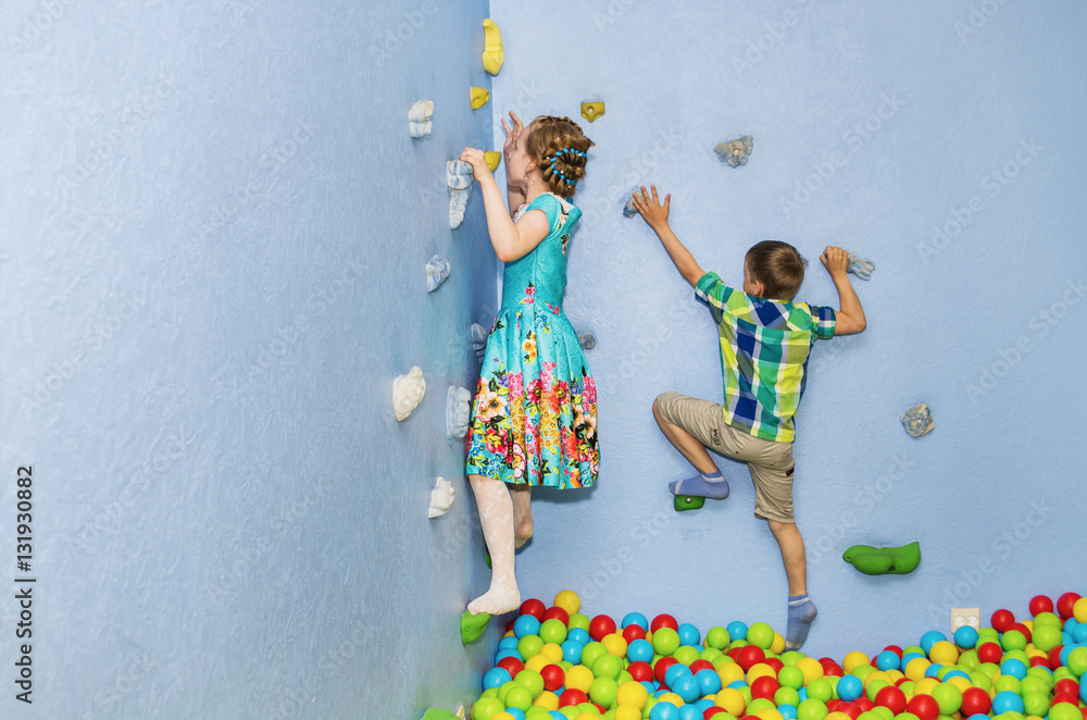 children play on the climbing wall