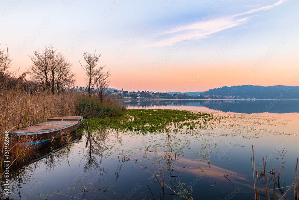 Fototapeta premium Lake Comabbio in autumn at sunset. On the background Varano Borghi; province of Varese, Italy 