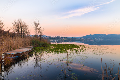 Lake Comabbio in autumn at sunset. On the background Varano Borghi  province of Varese, Italy     © AleMasche72