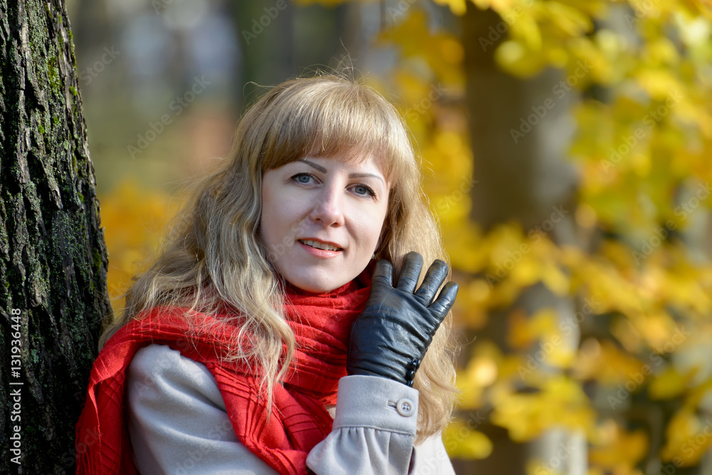 The young woman does up hair a hand in a black glove The young woman does up hair a hand in a black glove