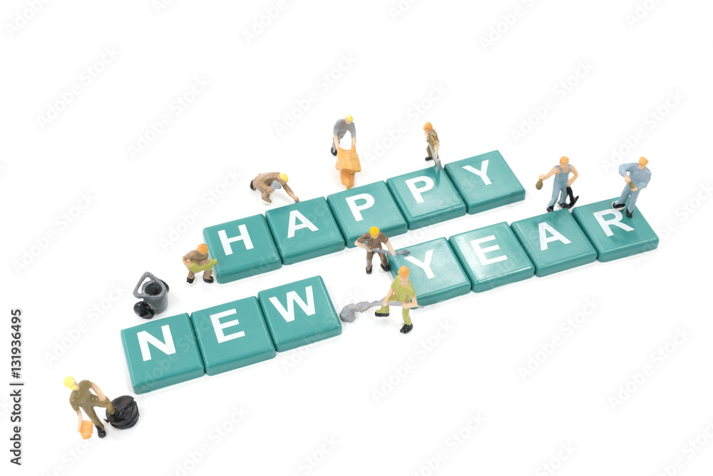 Miniature worker team building word happy new year on white back Miniature worker team building word happy new year on white back