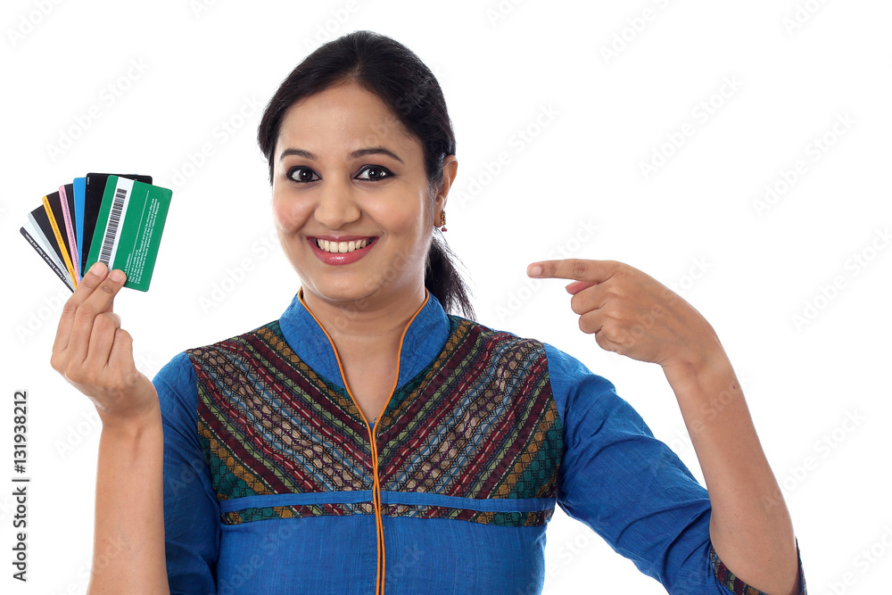 Cheerful Indian woman holding a bunch of debit cards-Cashless purchase concept Cheerful Indian woman holding a bunch of debit cards-Cashless purchase concept