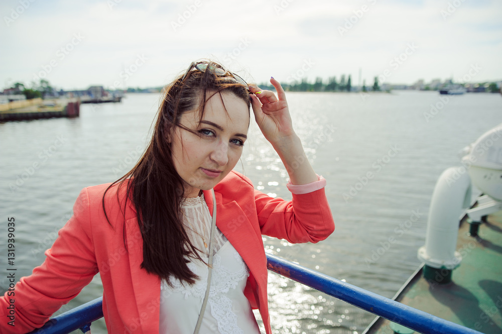 Young woman sailing on cruise liner or ferry with sea