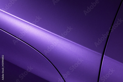 Surface of violet sport sedan car, detail of metal hood, fender and door of vehicle bodywork