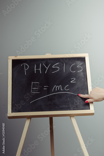Naklejka Physics word and formula E=mc2 on chalkboard
