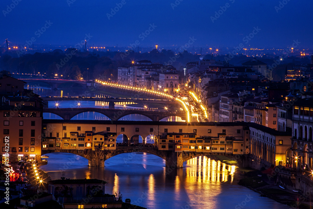 Florence, Italy's iconic Ponte Vecchio bridge at twilight viewed from the Piazzale Michelangelo