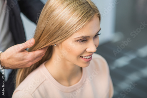 Smiling girl is sitting at the salon