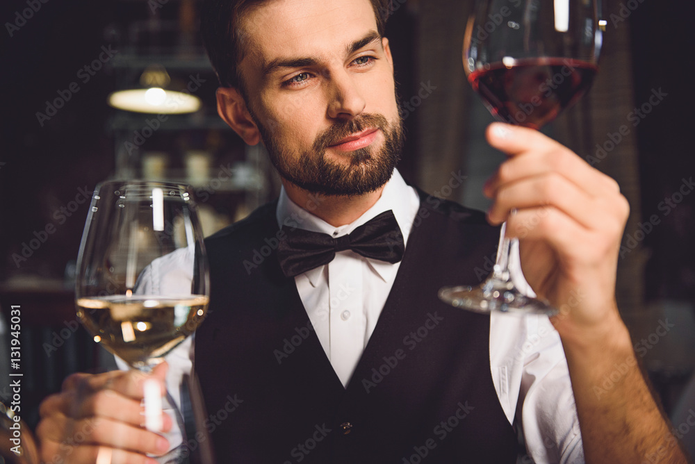 Immersed alcohol critic fixedly gazing at wine Immersed alcohol critic fixedly gazing at wine
