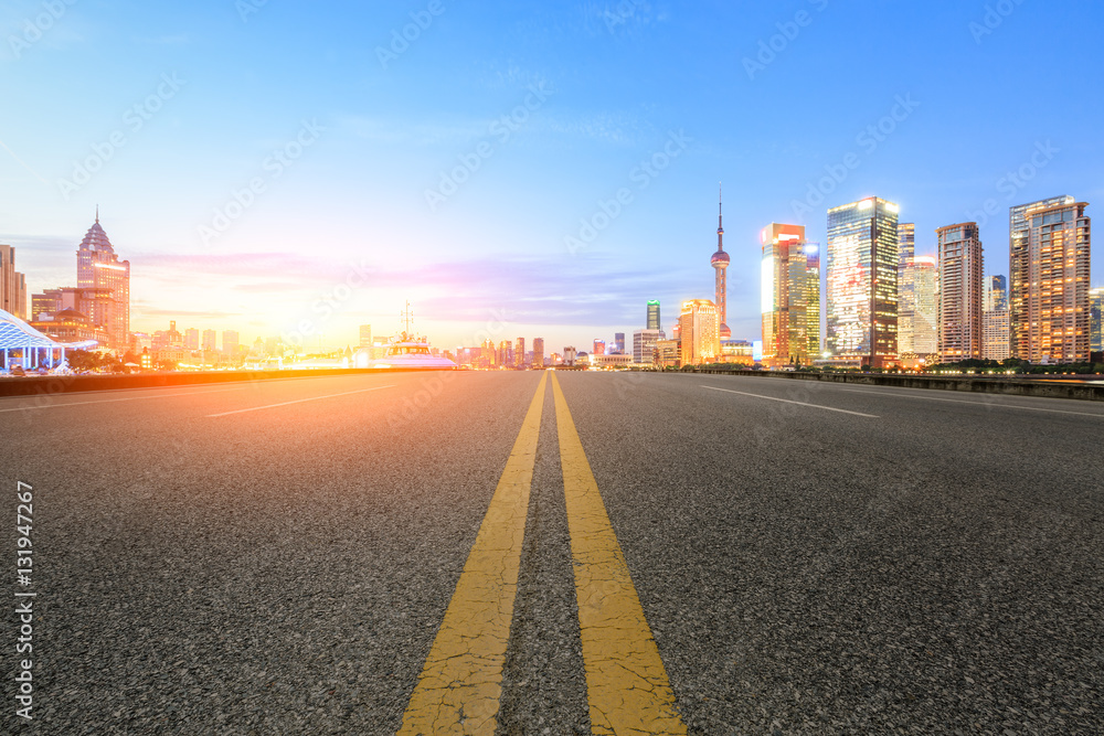 Asphalt road and modern cityscape at sunset in Shanghai Asphalt road and modern cityscape at sunset in Shanghai