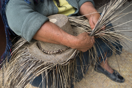 hand weaving a straw hat in San Bartolome Ecuador photo