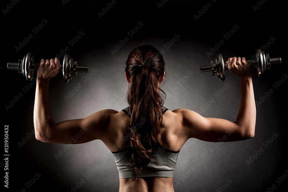 Atractive fit woman works out with dumbbells as a fitness concep Atractive fit woman works out with dumbbells as a fitness concep