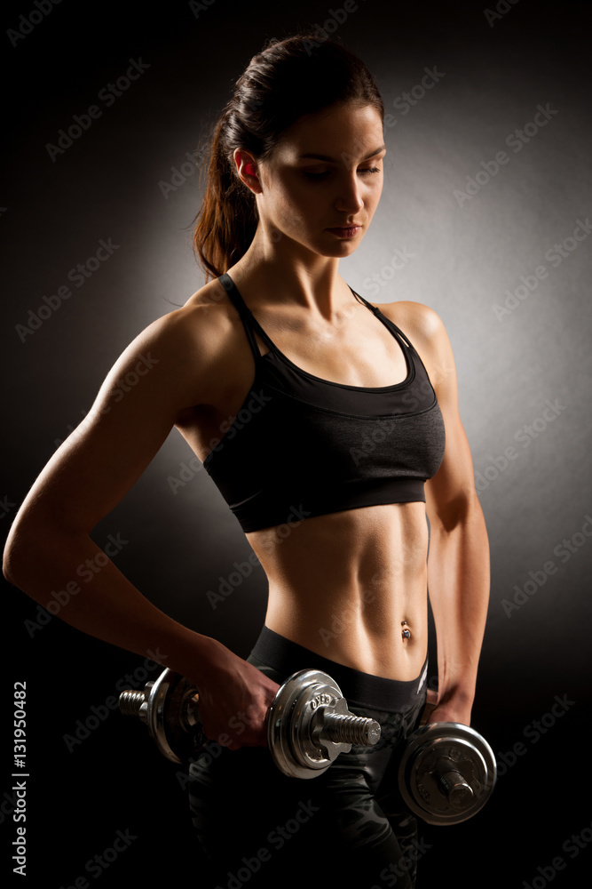 Atractive fit woman works out with dumbbells as a fitness concep Atractive fit woman works out with dumbbells as a fitness concep