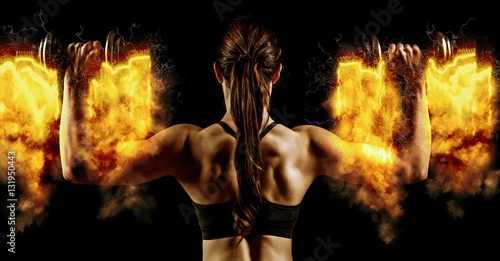 Fotografia Atractive fit woman works out with dumbbells as a fitness concep