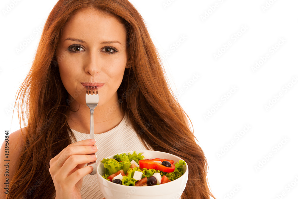 healthy eating - woman eats a bowl of greek salad isolated over healthy eating - woman eats a bowl of greek salad isolated over
