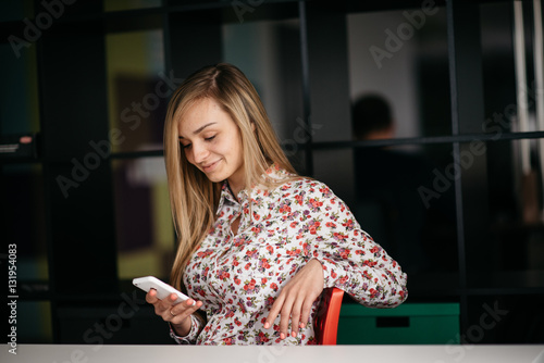 Cafe with wifi. Young attractive long hair woman using smart phone while sitting at restaurant