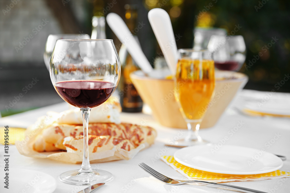 Plate, fork and glass of red wine on table, close up view Plate, fork and glass of red wine on table, close up view