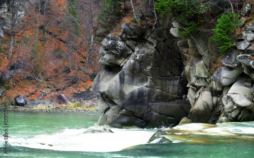 Mountain river flowing through autumn forest