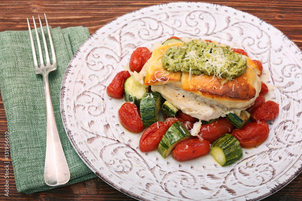 Tasty baked chicken breasts which basil pesto sauce, tomatoes, and cheese. Healthy eating concept. Tasty baked chicken breasts which basil pesto sauce, tomatoes, and cheese. Healthy eating concept.