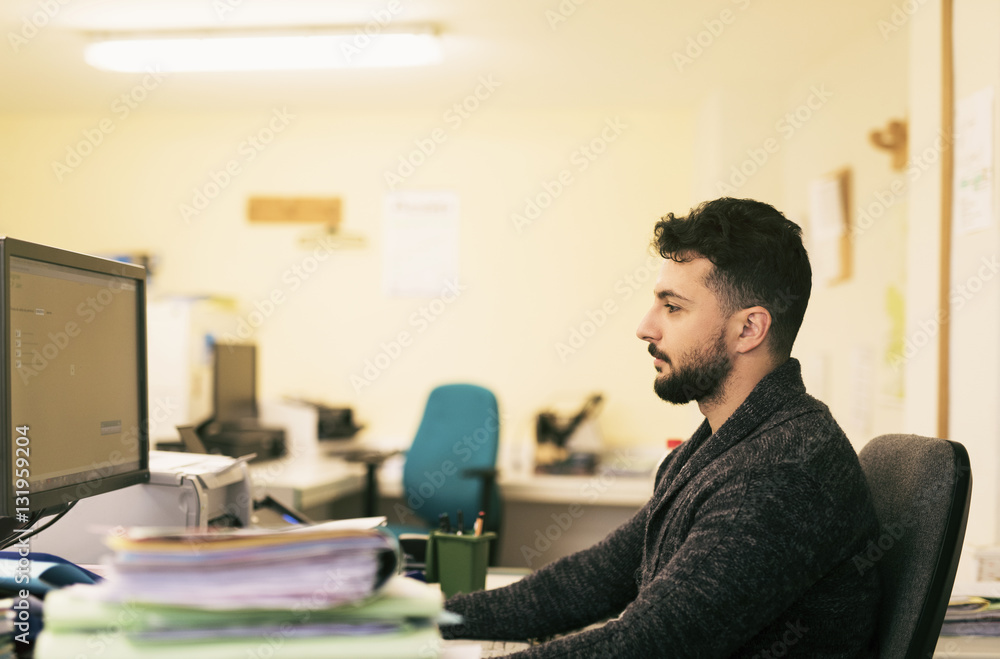 Bearded office clerk working with files Bearded office clerk working with files