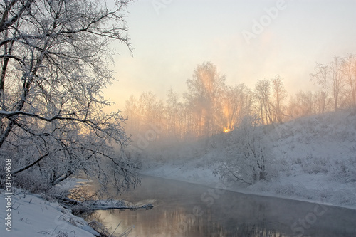 The sun's rays in a frosty morning on the river © Igor Sobolev