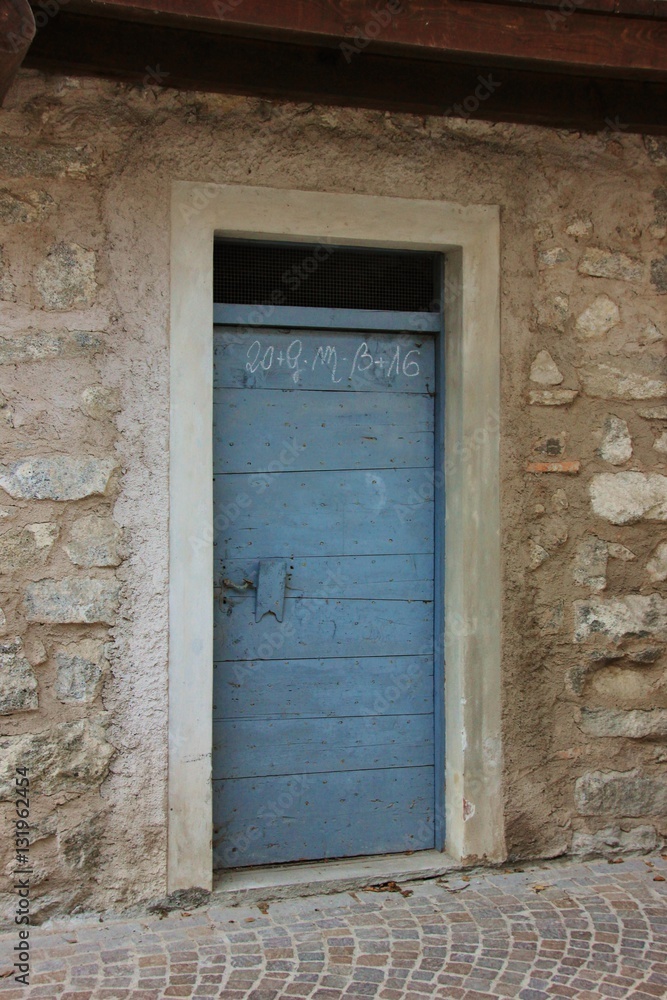 Blue wooden door. Rango, Trentino, Italy