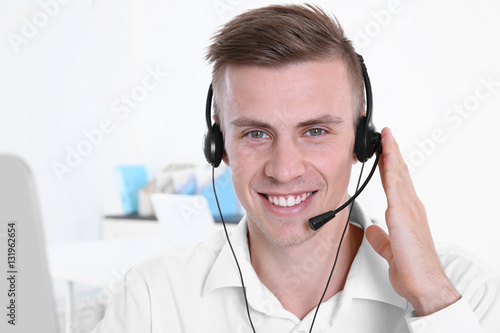 Young handsome technical support dispatcher working, closeup