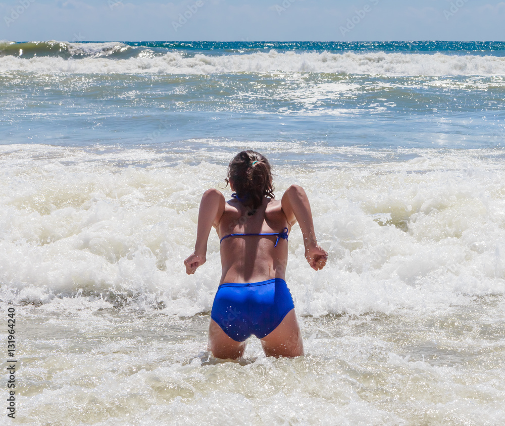 Girl bathing in the sea with a big wave.  Resort Albena, Bulgaria