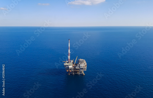 Image of oil platform while cloudless day - aerial view