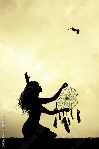 girl with dreamcatcher at sunset