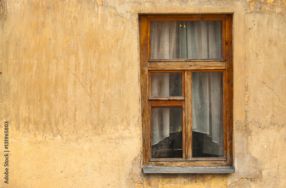 Old wooden window in an old painted wall