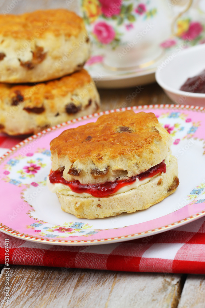 Traditional scone with strawberry jam and clotted cream
