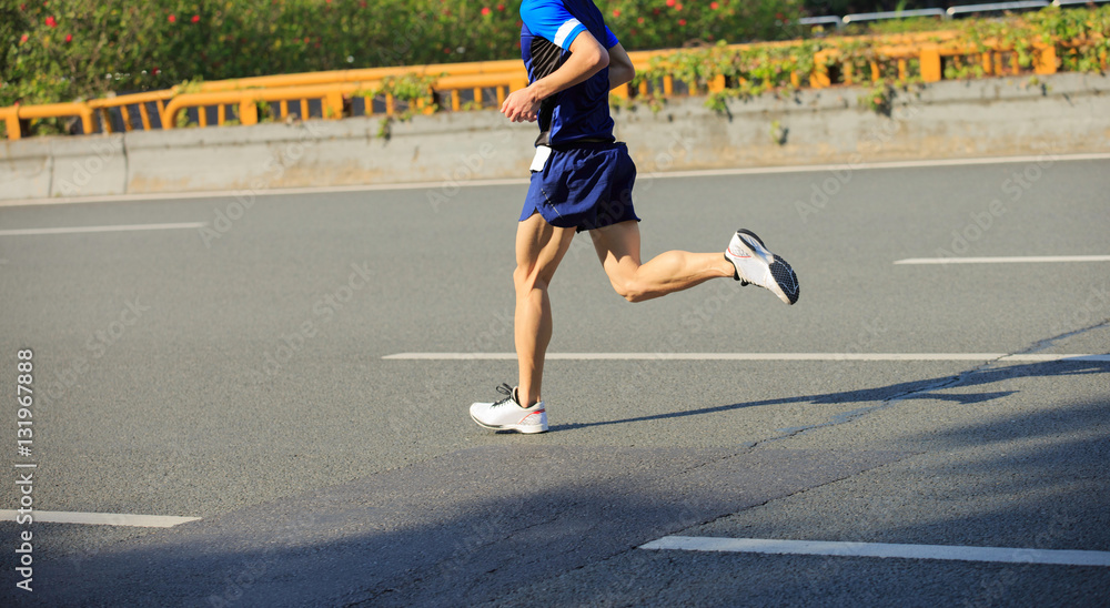 Fototapeta premium fitness male marathon runner running on city road