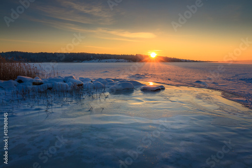 Winter landscape frozen ocean and sunrise