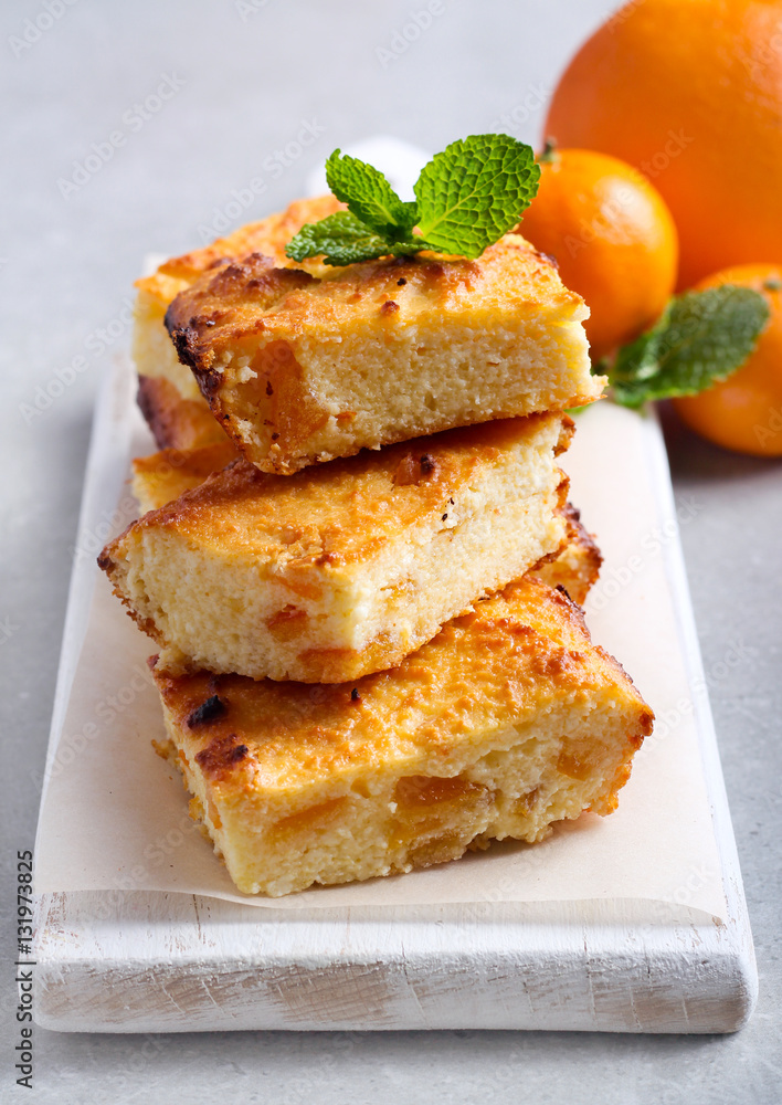 Orange cheesecake slices on board