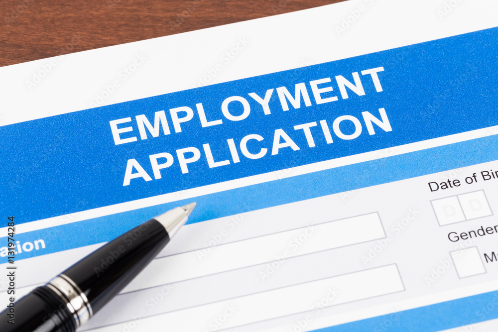 Employment application form with pen; document is mock-up Employment application form with pen; document is mock-up