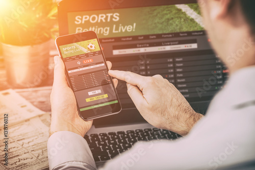 Photo betting bet sport phone gamble laptop concept
