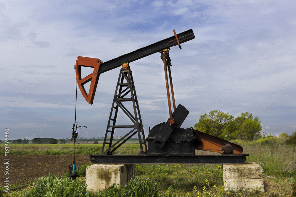 Oil derrick pumps petroleum on the field Oil derrick pumps petroleum on the field
