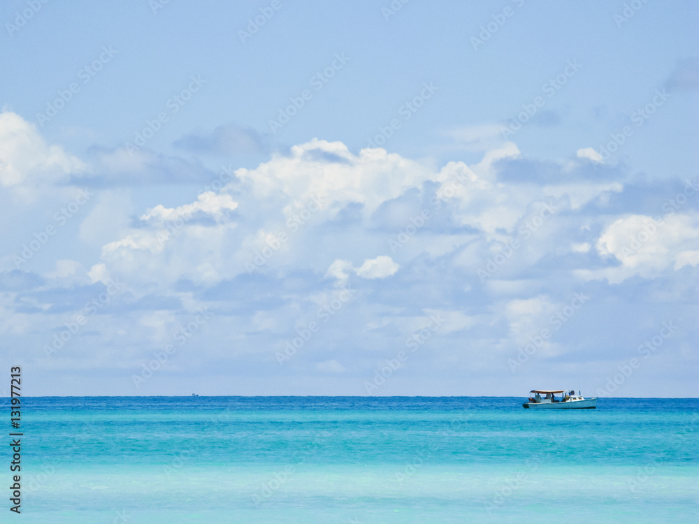 Fishing boat in the azure sea in calm weather.