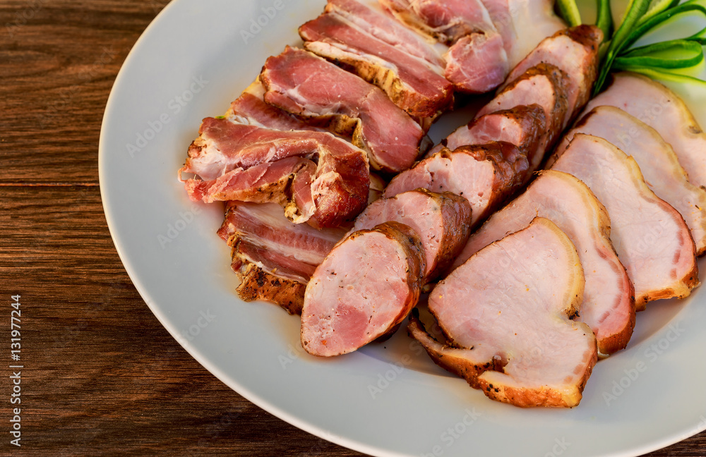 sliced pork sausage ham bacon wooden textured table in restaraunt. sliced pork sausage ham bacon wooden textured table in restaraunt.