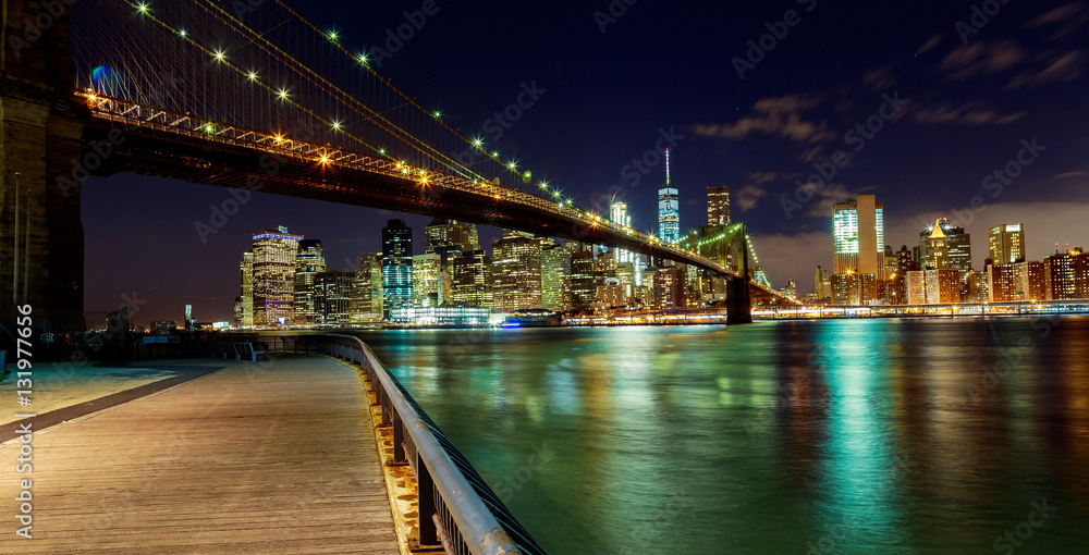 Naklejka premium New York City Brooklyn Bridge and Manhattan skyline Hudson River illuminated