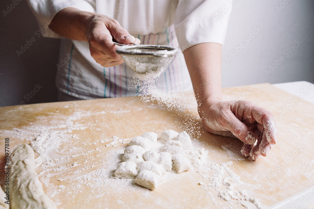 Front view of woman's hands making dough for meat dumplings. Front view of woman's hands making dough for meat dumplings.