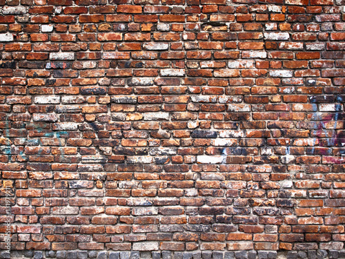 Old weathered red brick wall as background