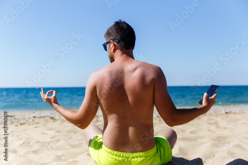 Tanned man relaxes on beach