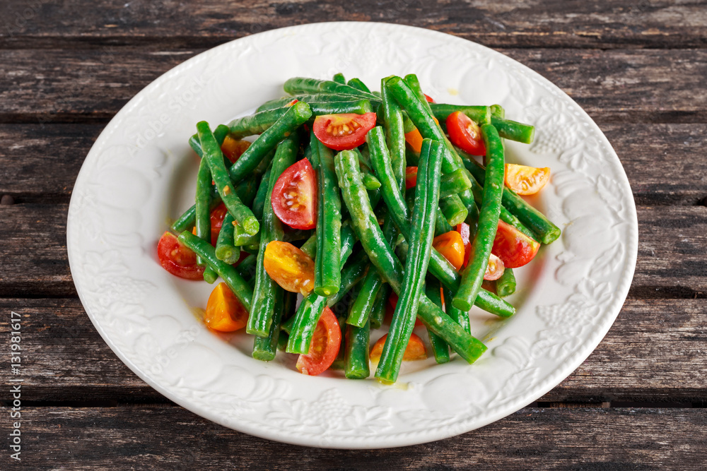 Green beans salad with Red, Yellow Tomatoes on white plate Green beans salad with Red, Yellow Tomatoes on white plate