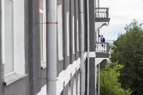 wedding couple standing on the balcony
