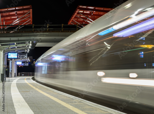 Train moving from the platform at night