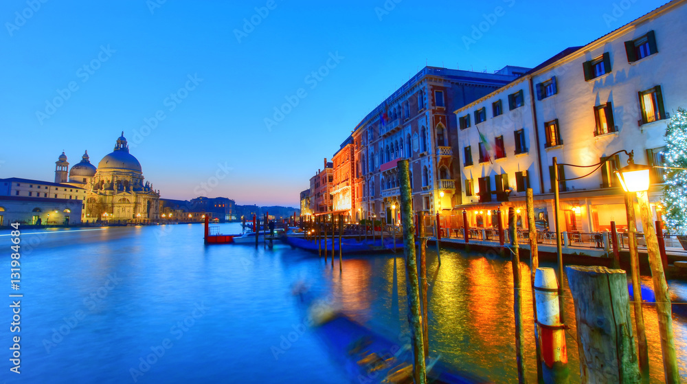 Beautiful night scene over the famous Grand Canal, with buildings illuminated in romantic lights, in Venice, Italy