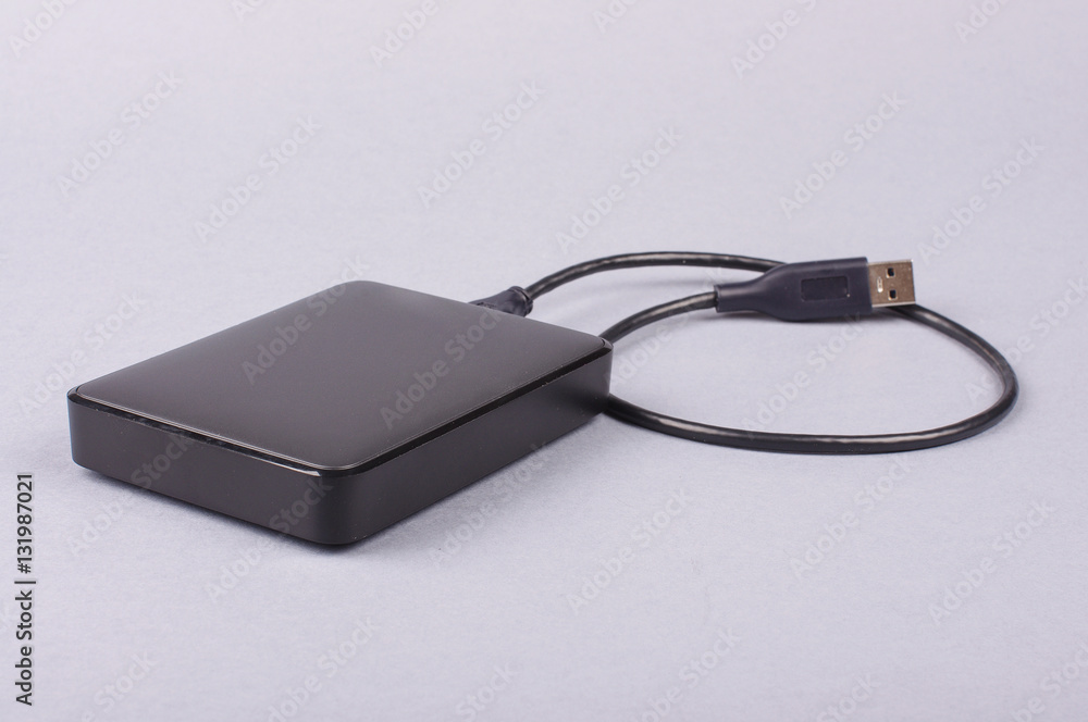 External 2.5'' hard drive HDD isolated on the gray background External 2.5'' hard drive HDD isolated on the gray background