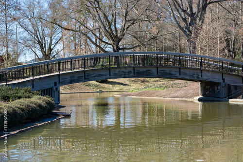 Arched bridge at a public park in Raleigh, North Carolina. Spring garden scene. Community area. 